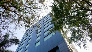 A modern building with a glass facade and multiple windows.