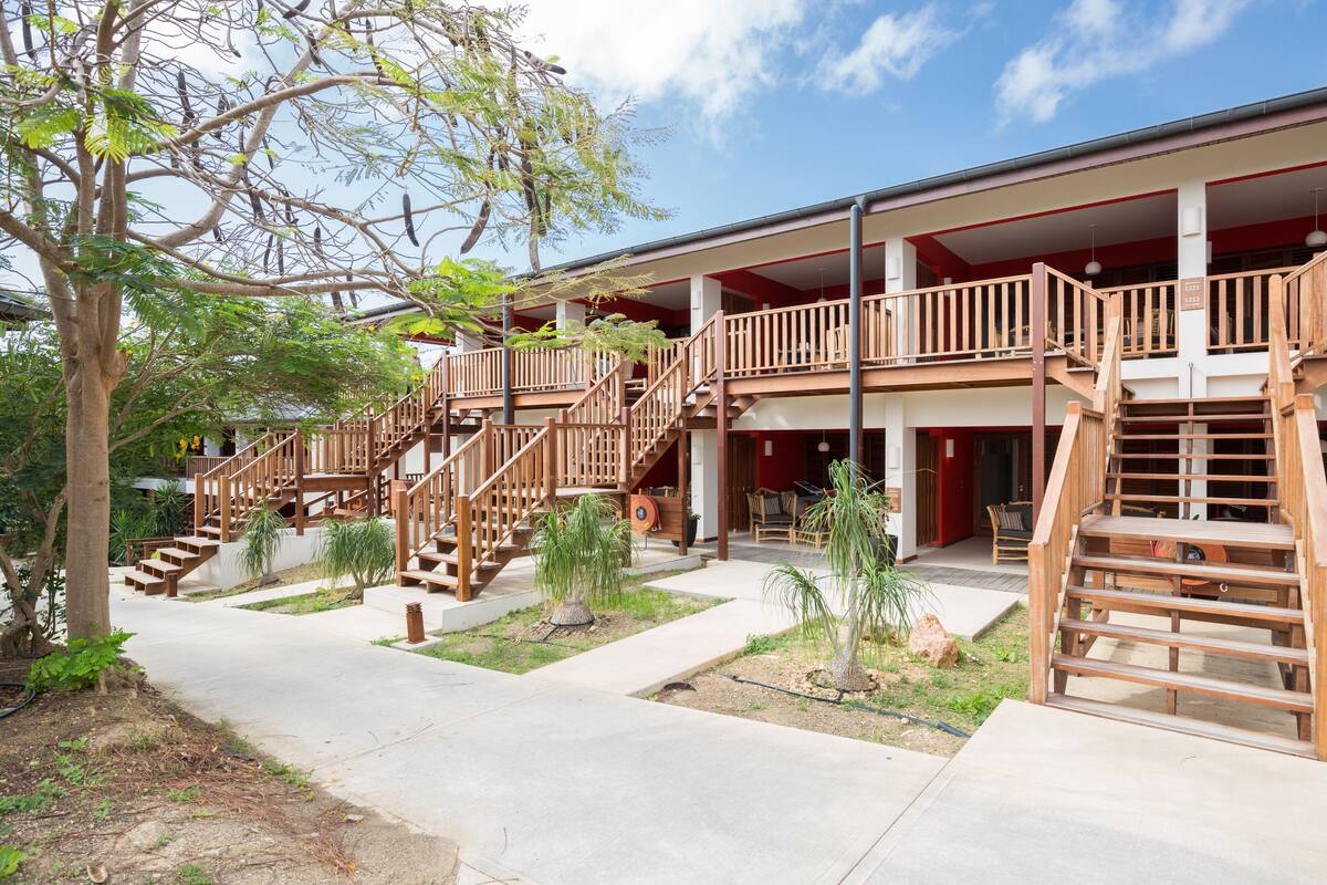 A multi-story building with wooden balconies and staircases.