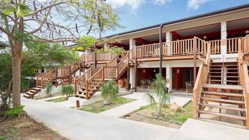 A multi-story building with wooden balconies and staircases.