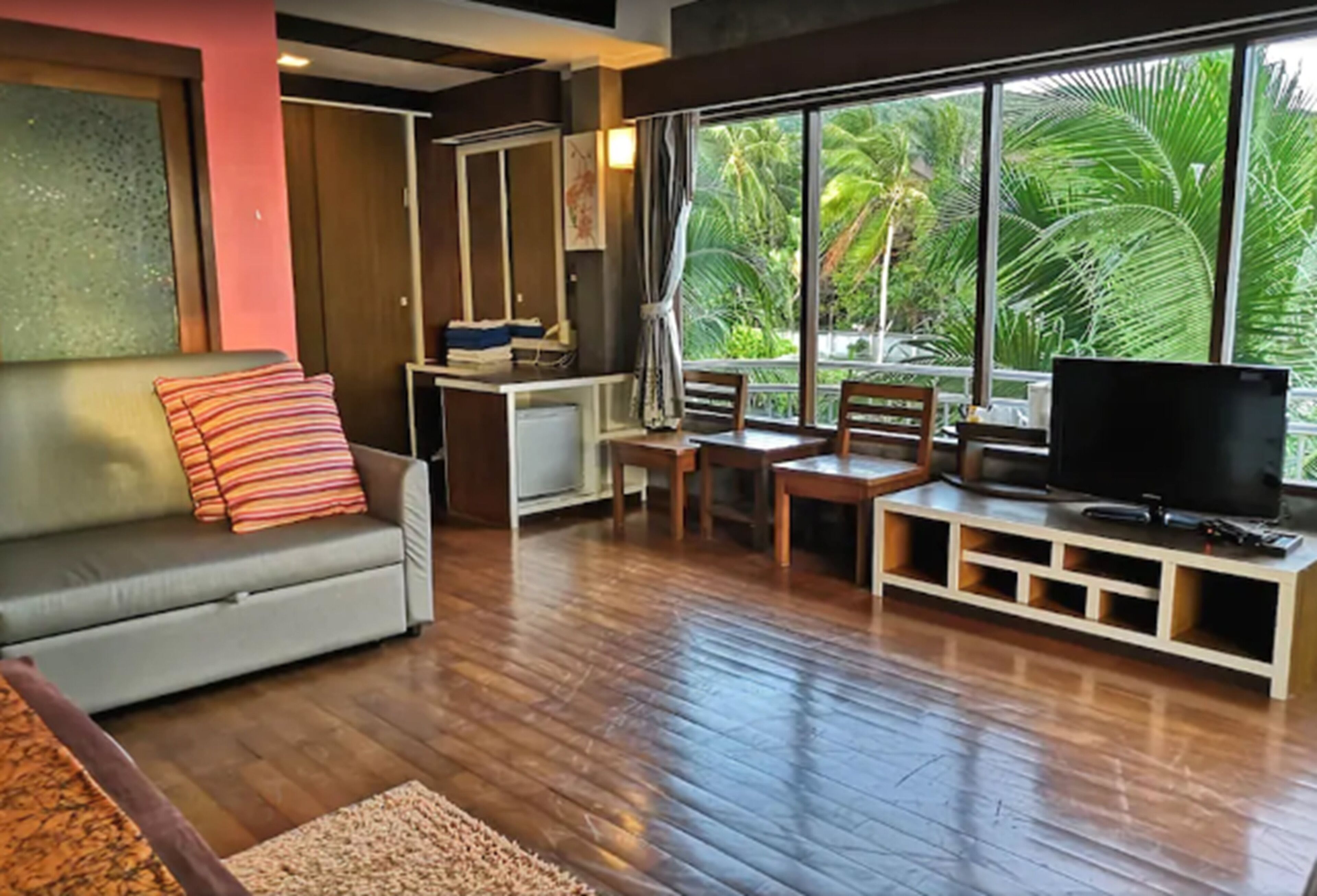 Deluxe Room, Pool View | Living area | 25-inch flat-screen TV with cable channels, TV