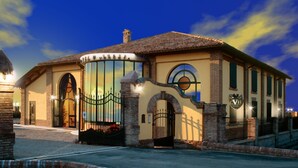 A hotel with a classic architectural style, featuring arched doorways and a prominent entrance gate. - Hotel Corte Vecchia (San Prospero)