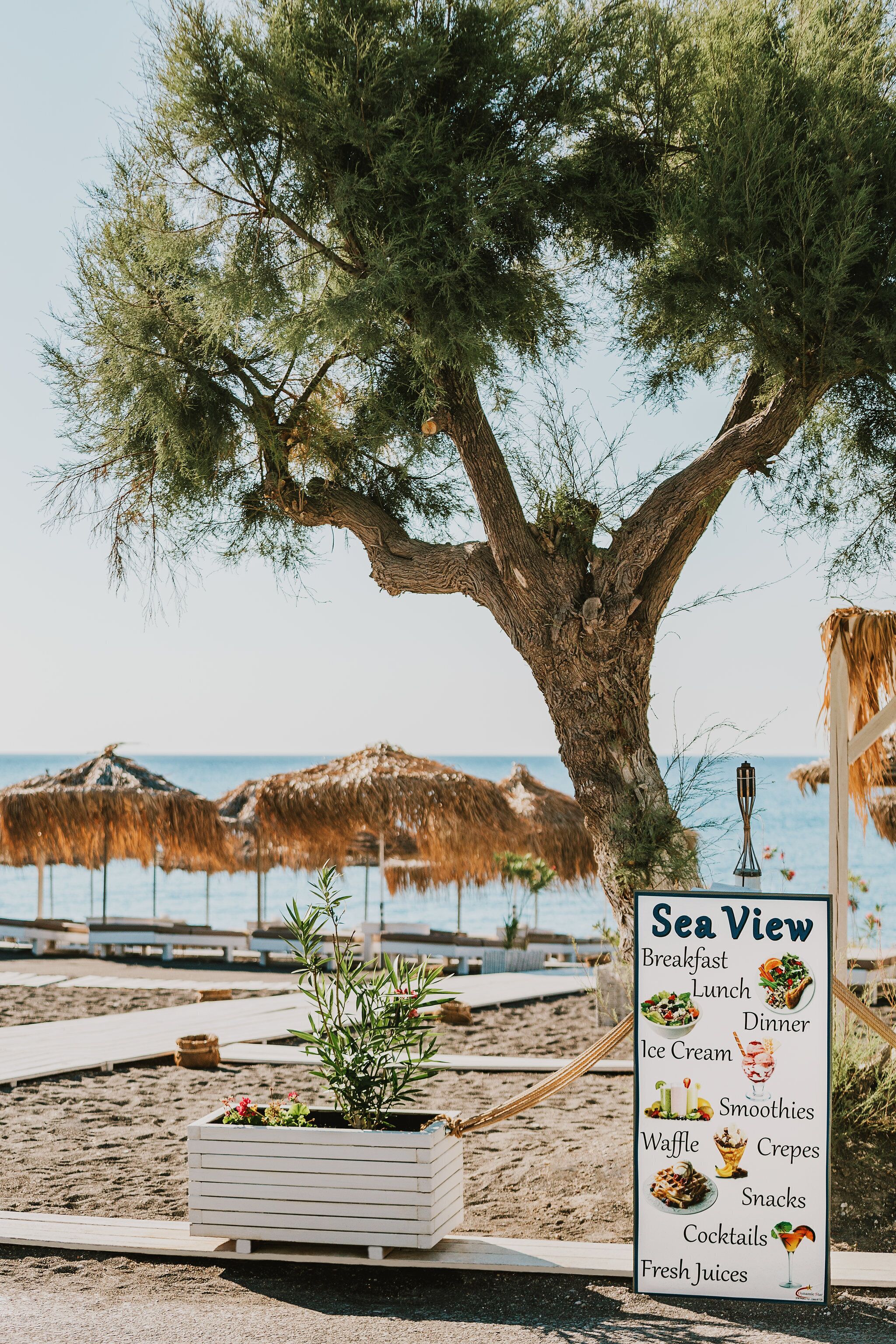 private beach, black sand, sun-loungers, beach umbrellas