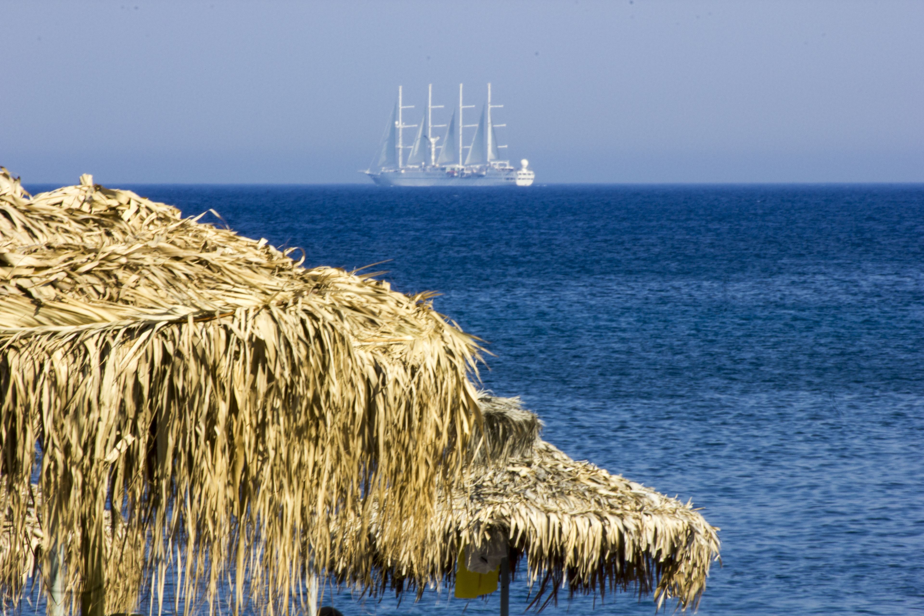 private beach, black sand, sun-loungers, beach umbrellas