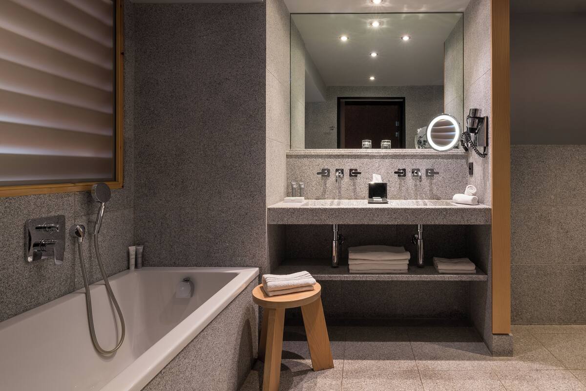 separate bathtub and shower, designer toiletries, hair dryer, bathrobes