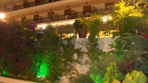 A multi-story hotel with balconies on each floor. - Hotel Merope (Samos)