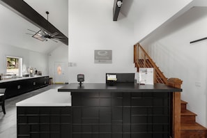 A reception desk with a black counter, a security camera, and a sign for EconoLodge.