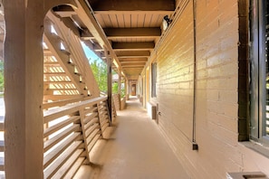 A covered corridor with wooden railings and brick walls. - Econo Lodge Inn & Suites Heavenly Village Area (South Lake Tahoe)