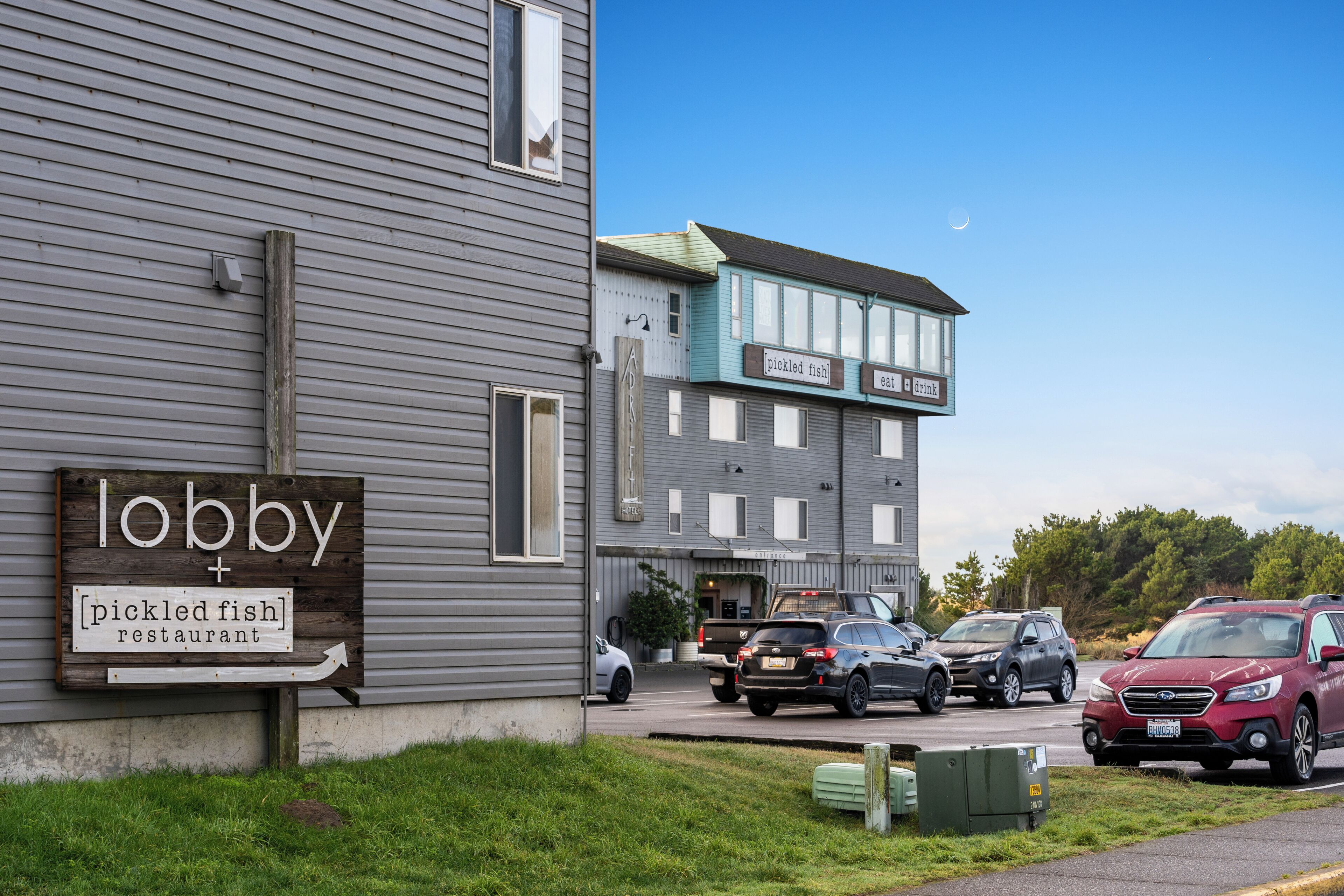 A building with a sign for 'lobby + pickled fish restaurant'.