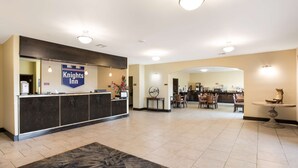 A hotel lobby with a reception desk, a dining area, and a reception counter. - Knights Inn Bunkie (Bunkie)