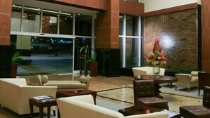 A spacious lobby with a high ceiling, large windows, and a seating area with sofas and tables. - Eurobuilding Hotel Plaza Guayana (Ciudad Guayana)