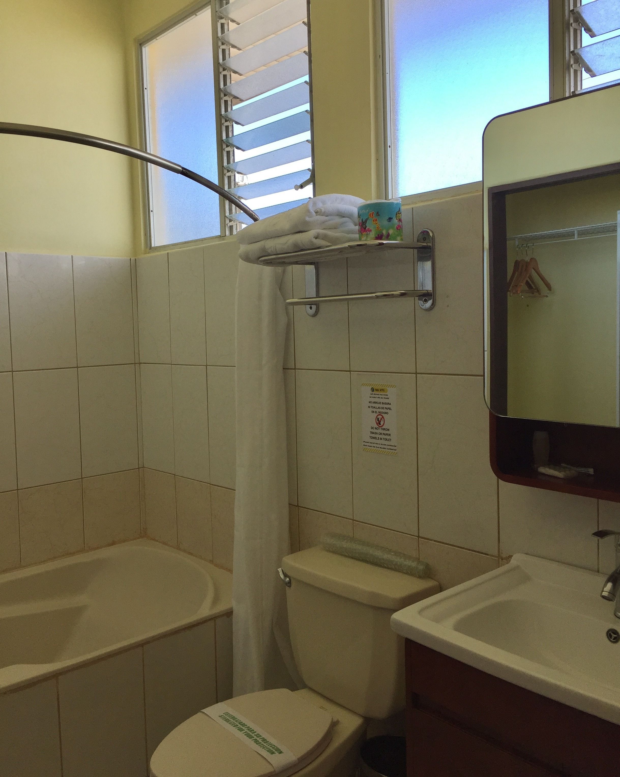 A bathroom with a toilet, sink, and shower.