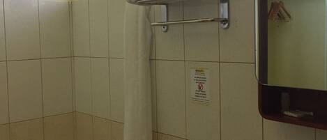 A bathroom with a toilet, sink, and shower.
