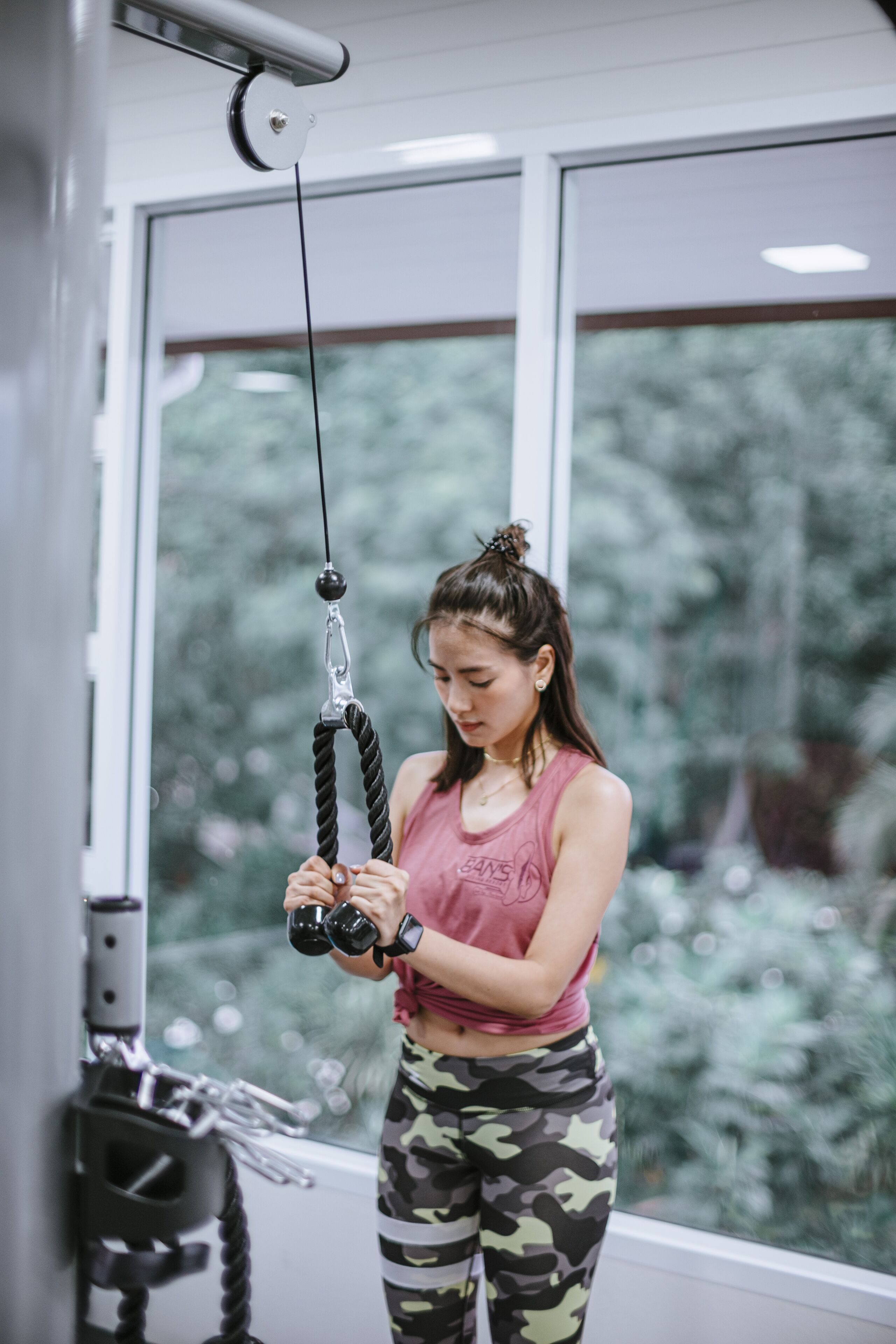 A person using a gym rope machine.