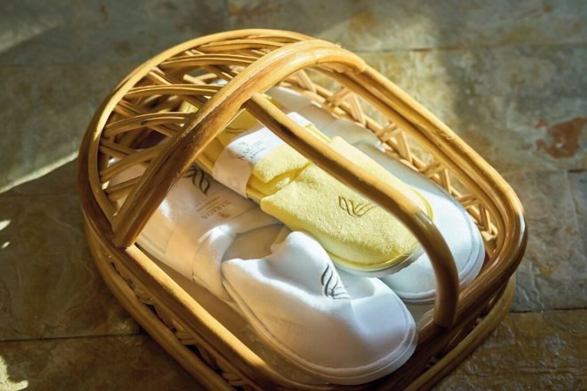 A wicker basket containing several pairs of shoes.