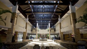 A spacious lobby with a central fountain, stone columns, and a reception desk. - NARADA Resort & Spa Liangzhu (Hangzhou)