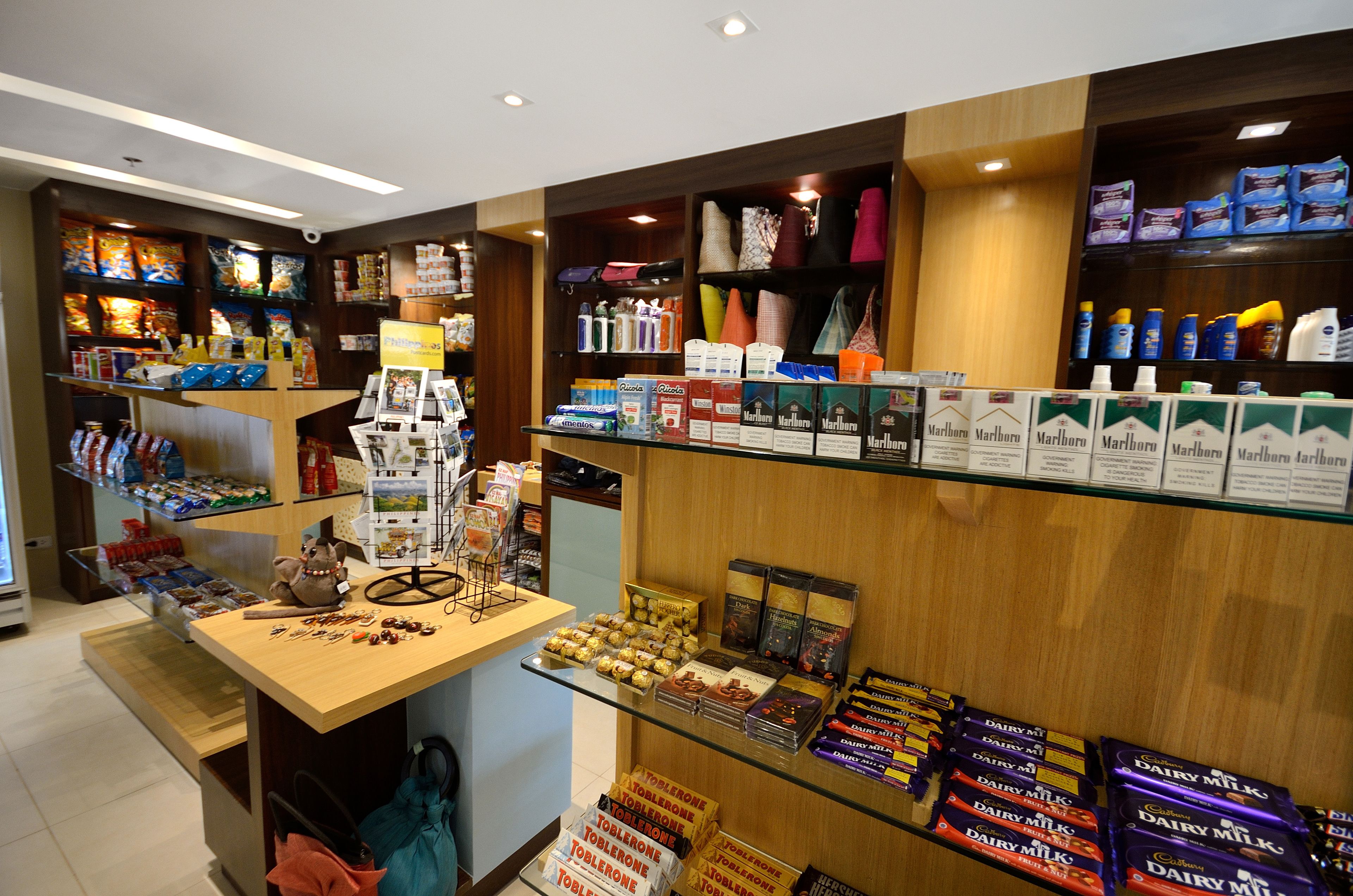 A retail store with shelves stocked with various products, including snacks, beverages, and personal care items.