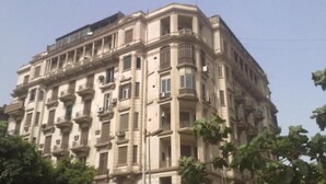 A multi-story building with a classical architectural style, featuring balconies and large windows. - Meramees Hostel (Cairo)