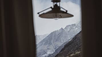 A mountain landscape with a silhouette of a hanging light fixture.