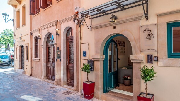 A boutique hotel with a classic facade, numbered 10, featuring arched doorways and a welcoming entrance. - Boutique Hotel Fortino (Chania)