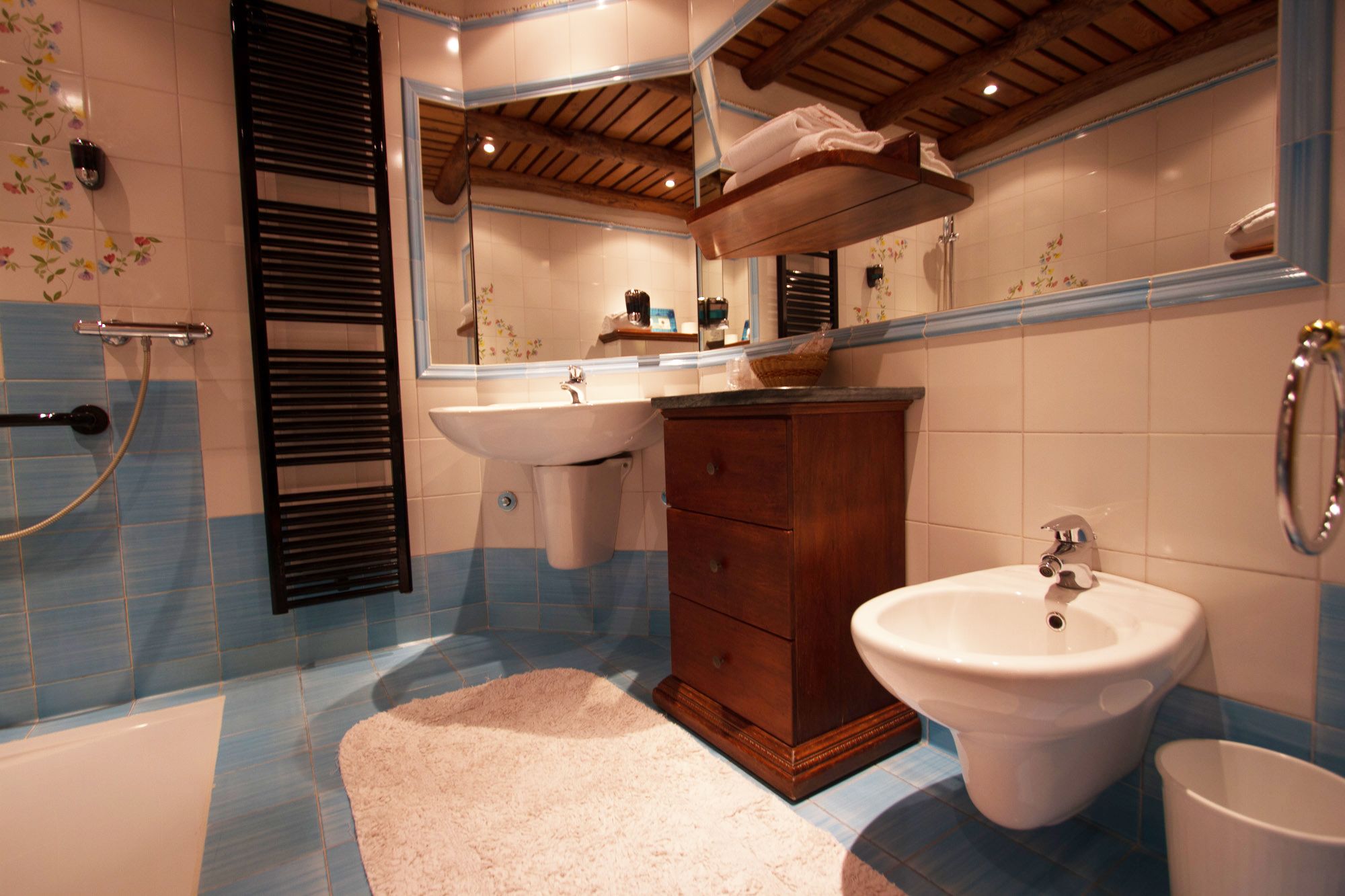 A bathroom with a sink, vanity, and bathtub.