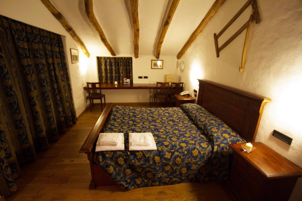 Une chambre avec un lit, un bureau et une chaise.