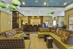 A lobby with a reception desk, seating area, and a sign for Kem's Lounge. - Holiday Inn Christiansburg Blacksburg by IHG (Christiansburg)