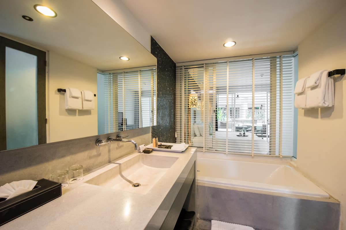 the pool paradise | bathroom | separate bathtub and shower, rainfall showerhead, free toiletries