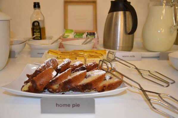 A breakfast buffet with home pie, warm milk, and other breakfast items. - Pure White (Prague)