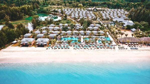 On the beach, sun-loungers, beach umbrellas, beach bar