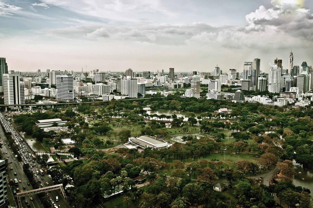 A cityscape with dense urban buildings, a river, and green spaces.