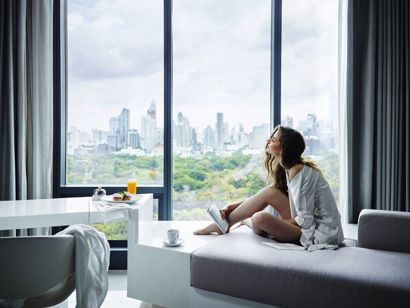 A modern hotel room with a large window offering a city view. - SO/ Bangkok (Bangkok)