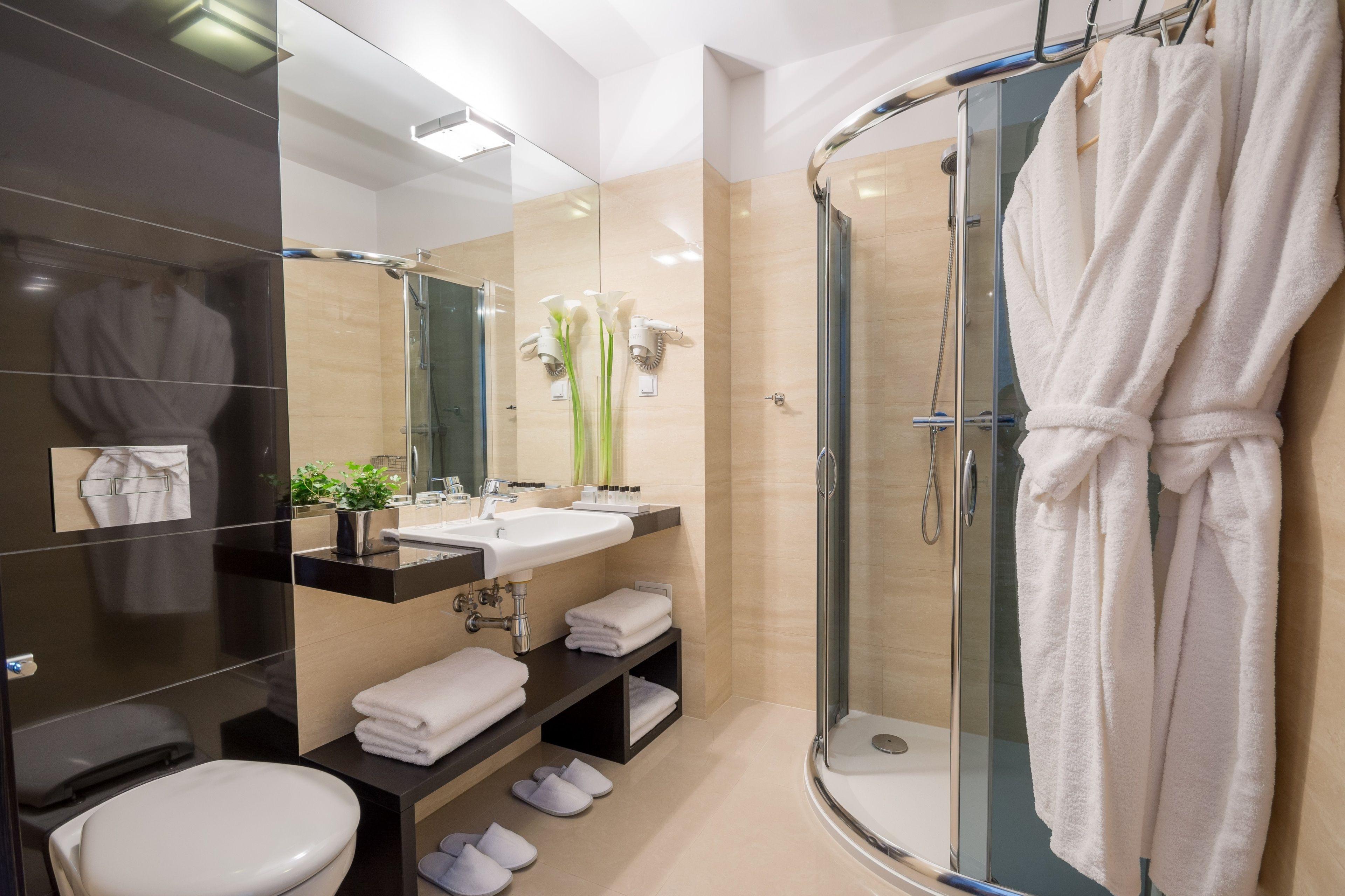 designer toiletries, hair dryer, bathrobes, slippers