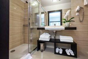 Designer toiletries, hair dryer, bathrobes, slippers