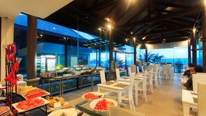 A buffet area with various food items and white chairs arranged for dining. - Samui Resotel Beach Resort (Koh Samui)