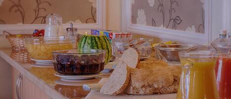A breakfast buffet with various food items and beverages.