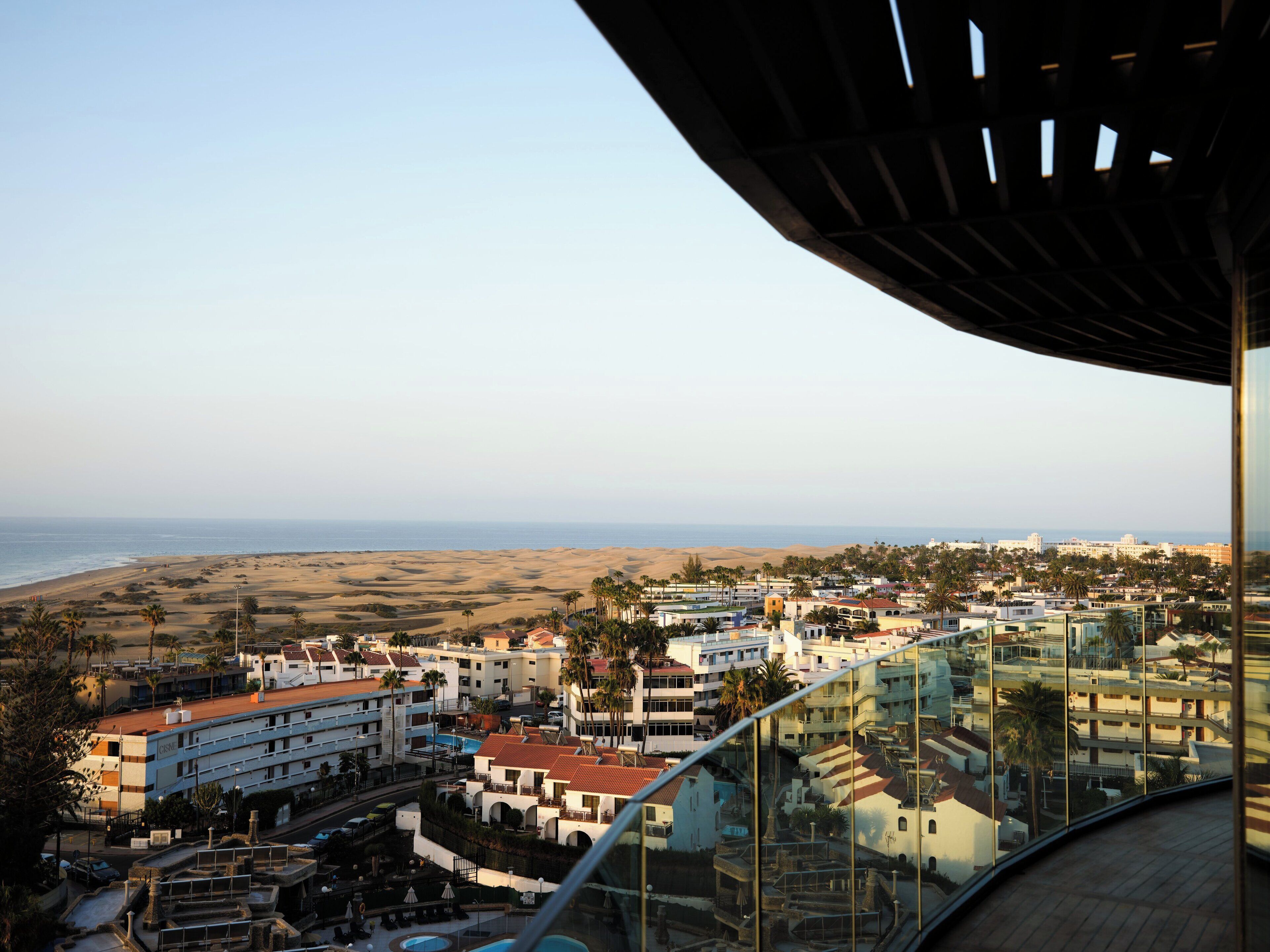 A coastal cityscape with a view of the beach and ocean.