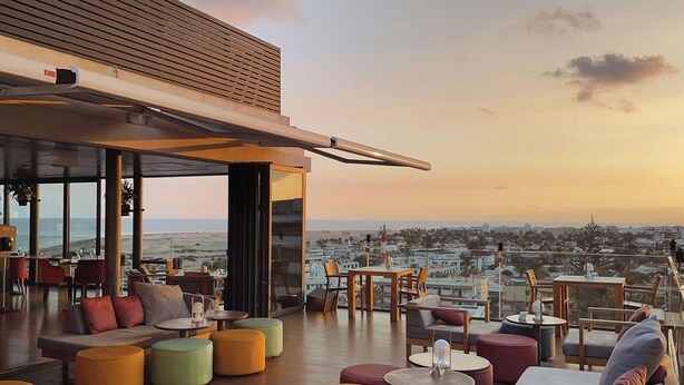 A rooftop terrace with seating, a view of the city, and a sunset. - Bohemia Suites & Spa - Adults only (San Bartolomé de Tirajana)