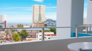 A balcony with a view of a cityscape, including high-rise buildings and a road with vehicles. - Dorados Acapulco (Acapulco)