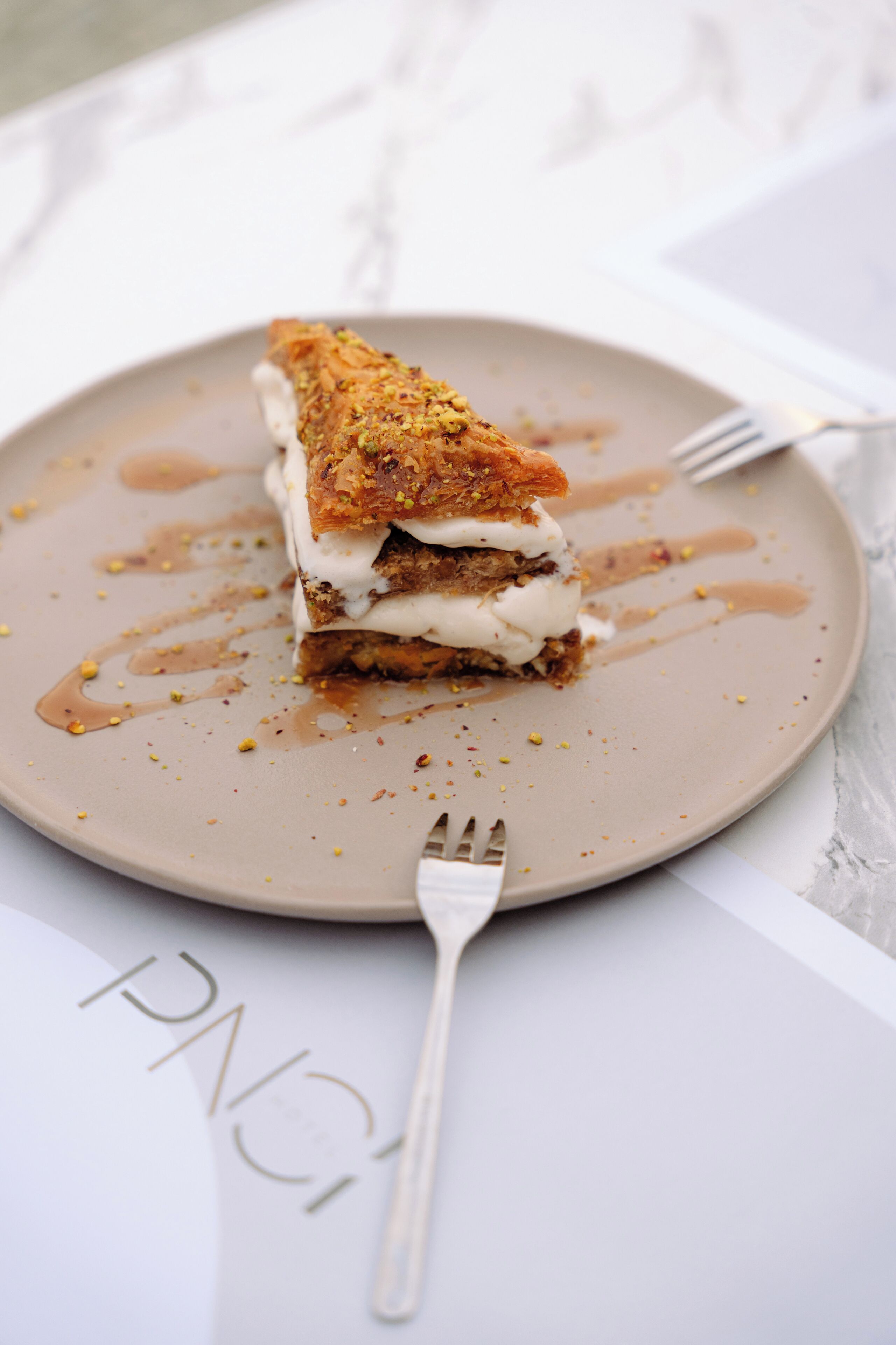 A dessert on a plate with a fork beside it.