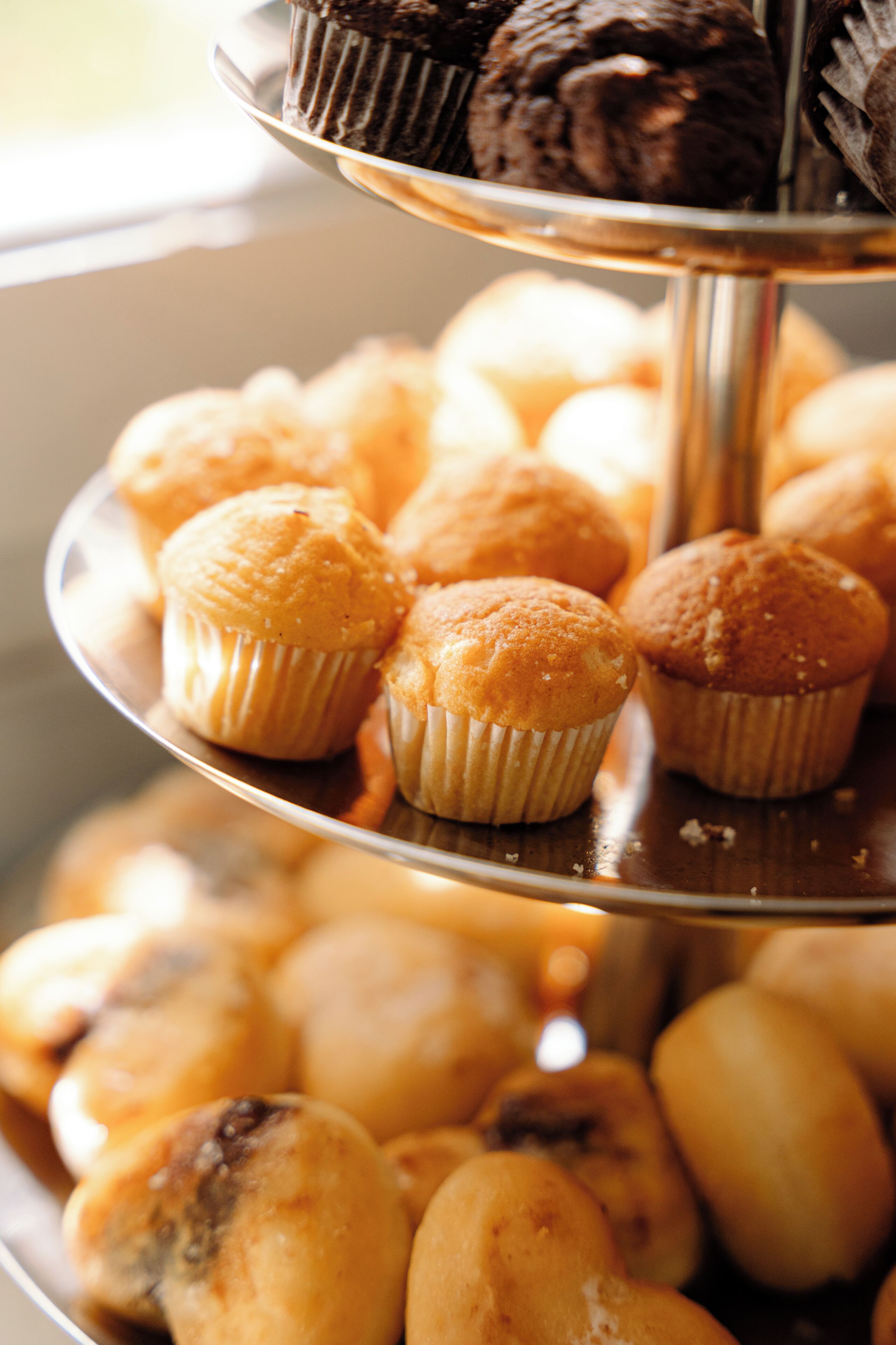 A tiered tray with muffins and brownies.