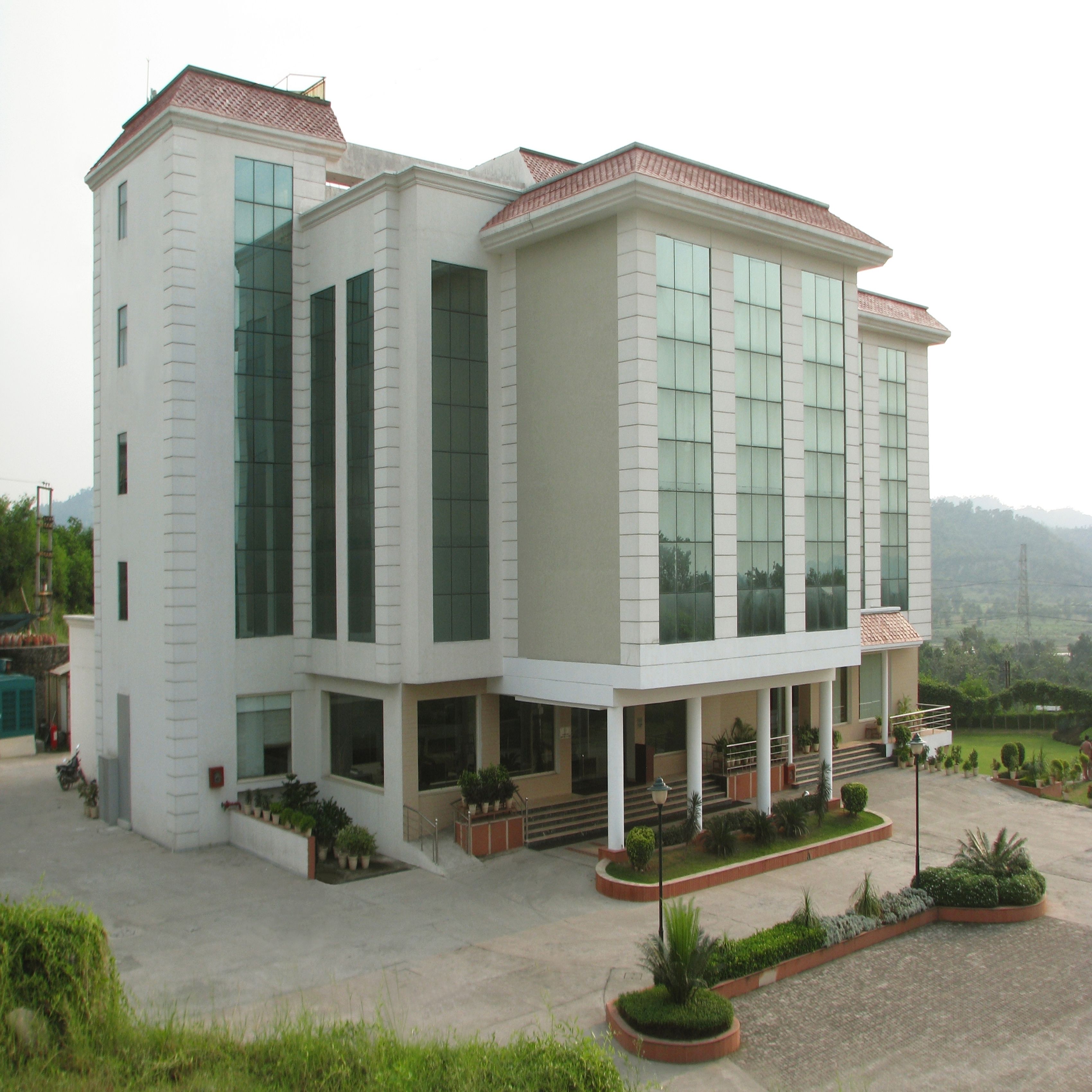 A modern two-story building with large windows and a flat roof.