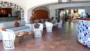A spacious lobby with a tiled floor, a reception desk, and seating areas with white chairs and a sofa. - Hotel Hacienda Vallarta Playa Las Glorias (Puerto Vallarta)