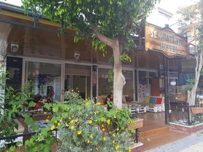 A hotel entrance with a sign reading "SEMPATI A&P HOTEL".