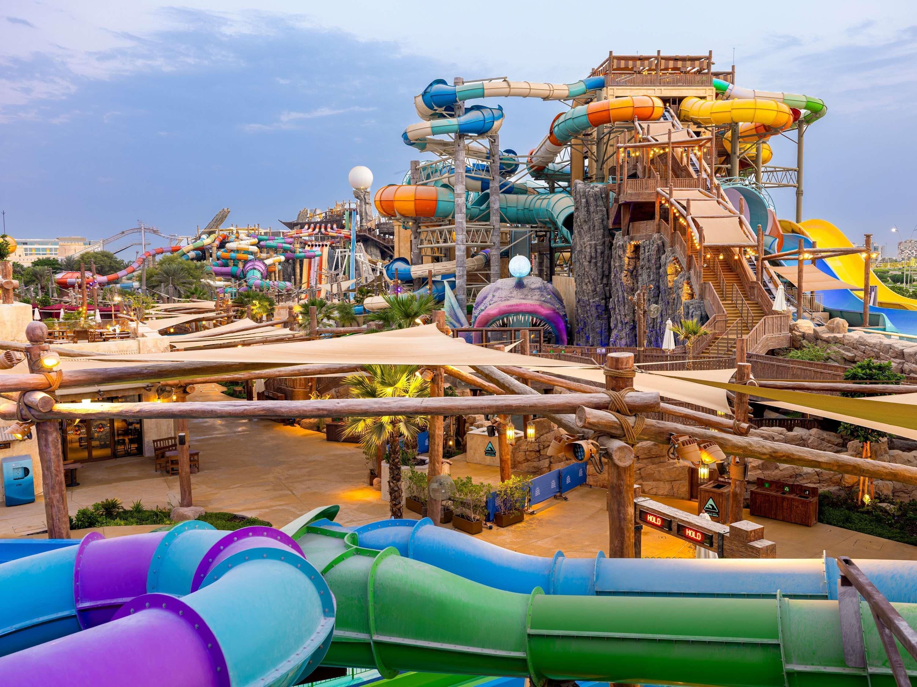 A water park with various slides and a large water tower.