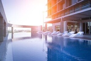2 outdoor pools, open 6:00 AM to 10:00 PM, pool umbrellas, sun loungers