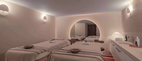 Un cuarto de spa con dos camillas, un espejo grande y un tocador con artículos de aseo.