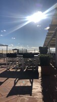Una terrazza sul tetto con posti a sedere all'aperto e vista sullo skyline cittadino.