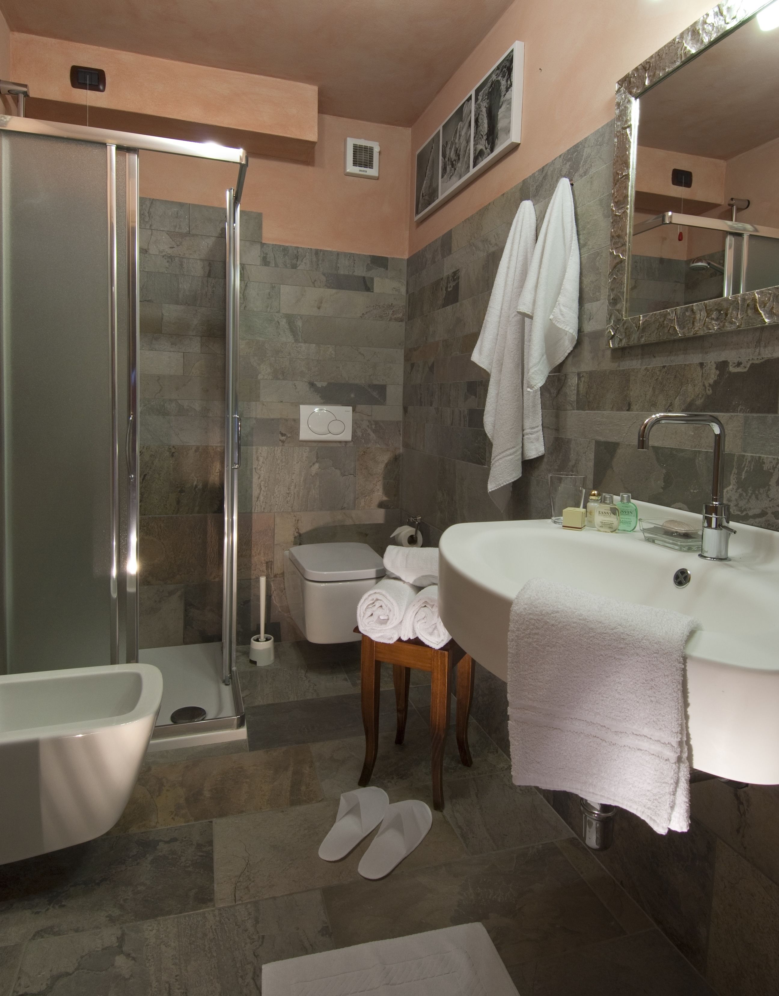 A bathroom with a shower, toilet, and sink.