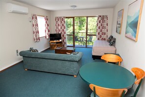 1 Bedroom Deluxe Spa | Living area | 32-inch flat-screen TV with satellite channels, TV, DVD player