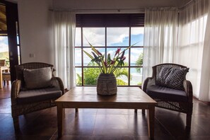 Villa, 1 Bedroom, Ocean View | Living area | 50-cm flat-screen TV with cable channels, TV, books - Villas de Jardin (Mahé Island)